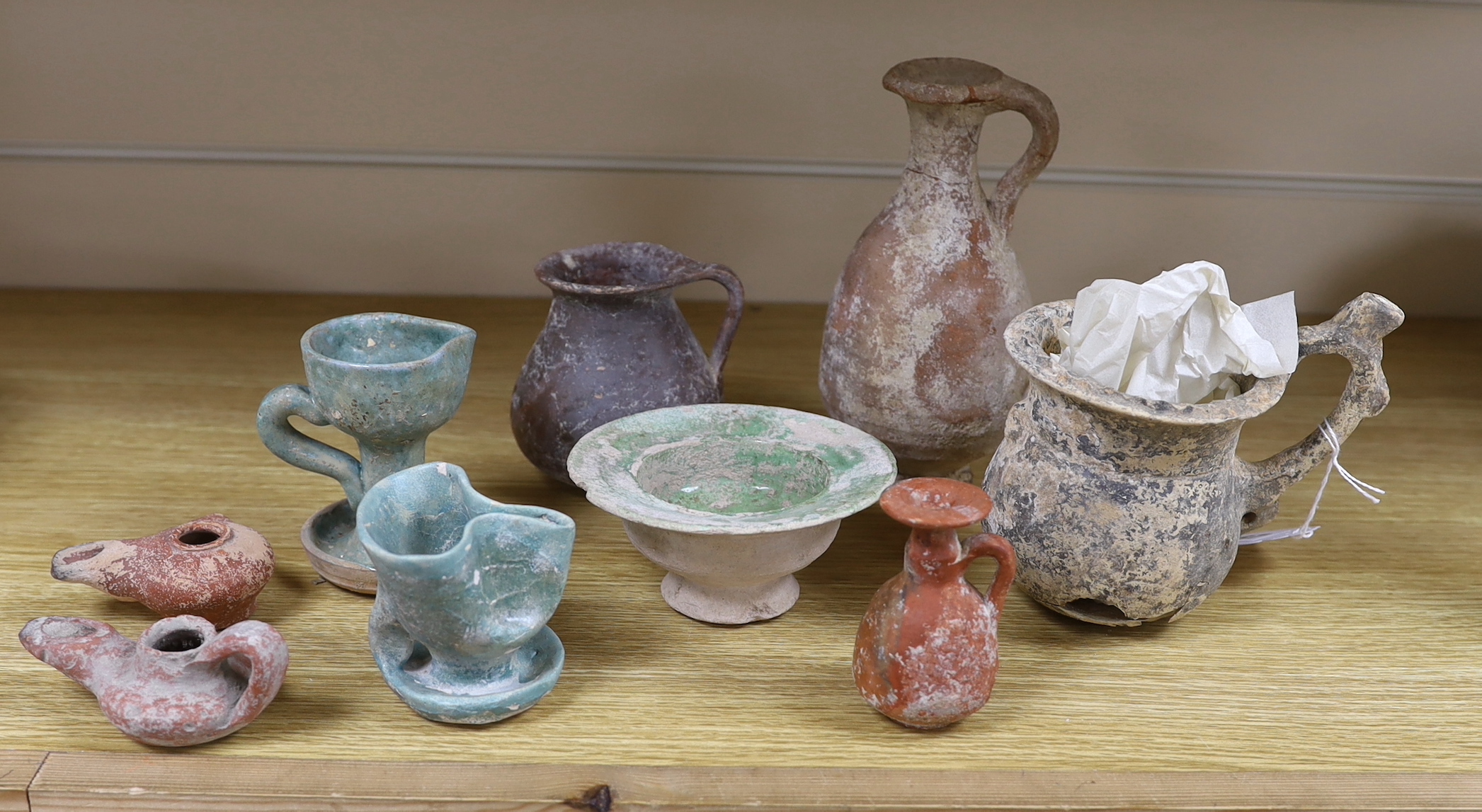 A group of pottery ‘antiquities’, to include Roman, early Christian, Byzantine and Syrian, the largest 17cm high (9), provenance: the owner collected these items in the 1970s, some with original receipts